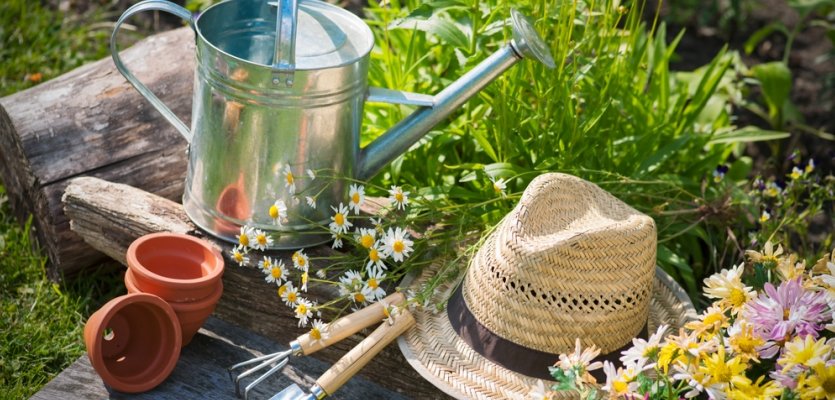 Gardening  Gardening tools and a straw hat on the grass in the garden elearning brothers