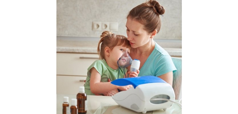 woman makes inhalation to a child at home. brings the nebulizer elearning brothers